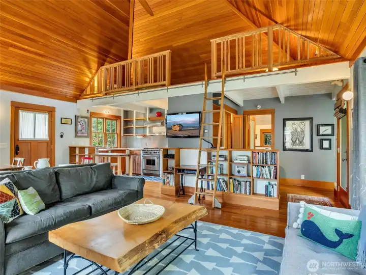 Living area with extensive built-ins and warm wood finishes. reclaimed wood ceiling from an old lumberjack bar in Oregon.