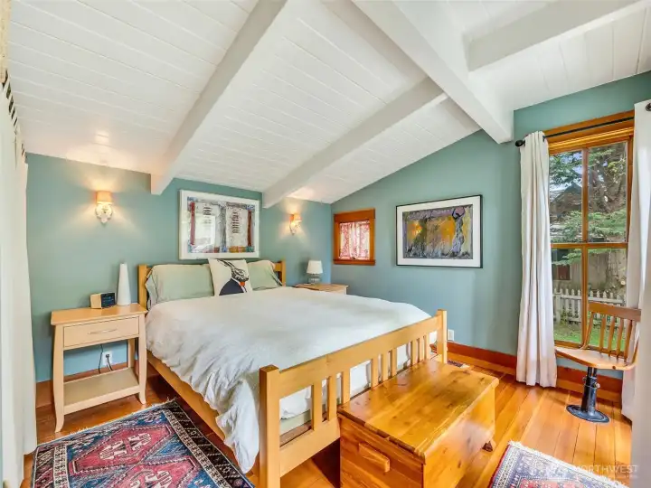Bedroom with simple layout and natural light overlooking the backyard.