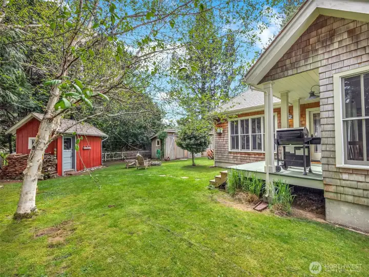 Backyard with lawn and mature landscaping