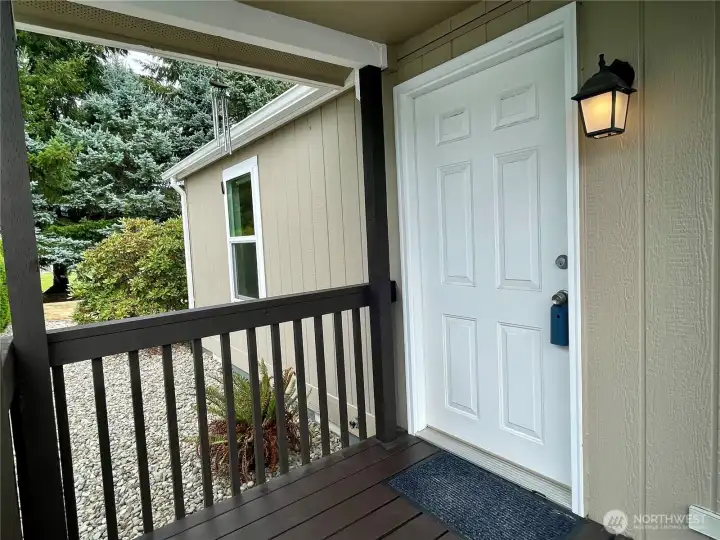 Covered front porch with ramp leading to entry