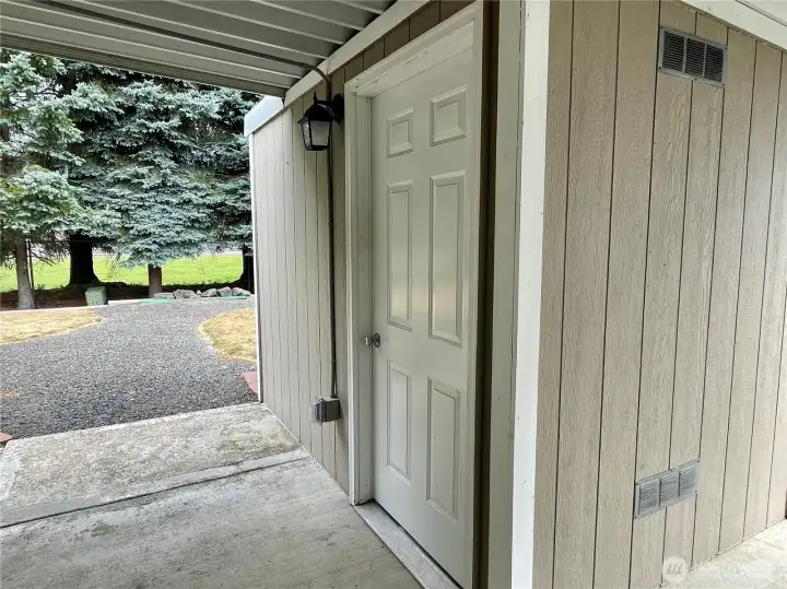 Storage shed beyond carport