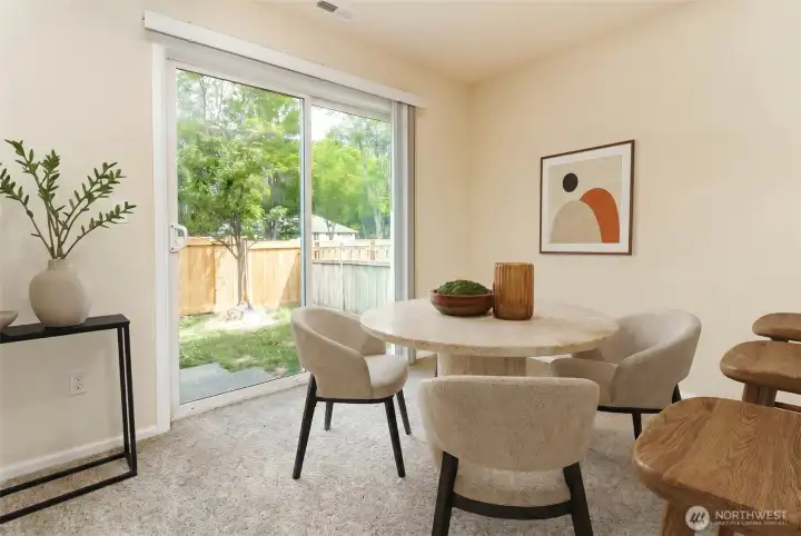 Dining Area  Open dining space conveniently located next to the kitchen with breakfast bar seating, perfect for casual meals and gatherings.