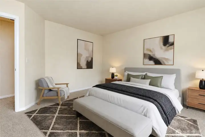 Spacious Primary Suite  Expansive primary bedroom featuring abundant natural light, plush carpeting, and plenty of room for a sitting area.