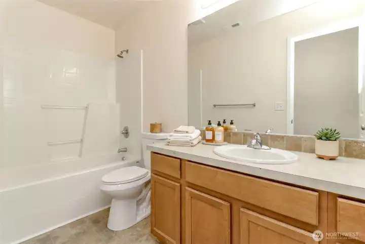 Hall Bathroom  Bright full bathroom featuring an extended vanity, abundant counter space, and a tub/shower combination.