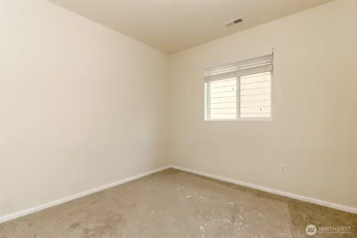 Bedroom 2  Comfortable secondary bedroom with soft carpeting, natural light, and flexible space for family or guests.
