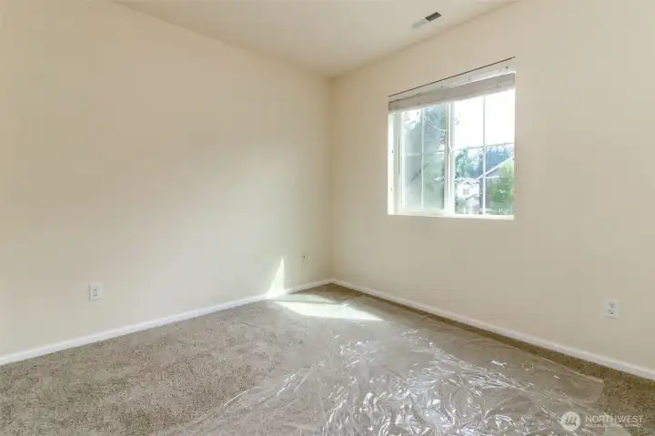 Bedroom 3  Bright and inviting bedroom with a large window and ample closet space, ideal for guests or a home office.