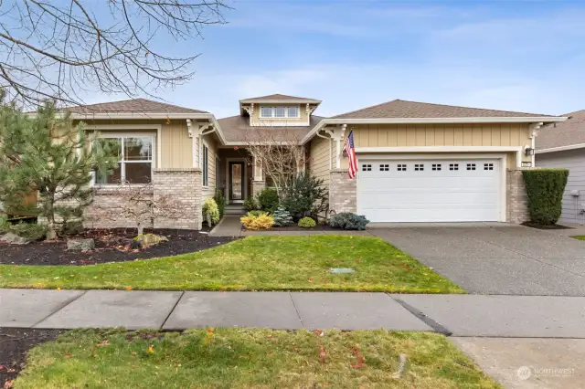 The Canterwood floor plan with a grand covered entry and patio. Spacious two car garage. Stone accents on exterior.