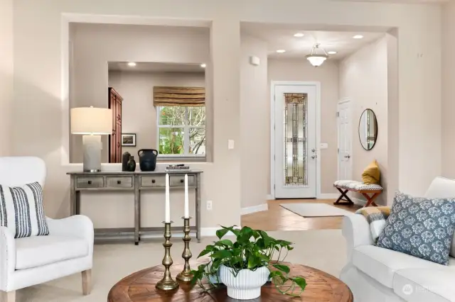 Showing off foyer with leaded glass door, den to the left and living room with 10 foot ceilings through out.