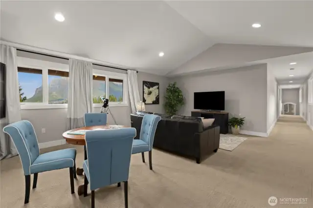 From the primary wing, walk across the catwalk to the secondary wing. It includes this rec room and 3 bedrooms and a Jack-n-Jill bathroom down the hallway. Plenty of room to grow! Close the door to this wing and have a party downstairs without waking anyone up!