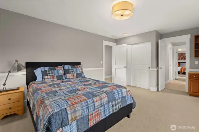 Bedroom 2 upstairs in the secondary wing. It has a window seat with built-in storage along with a built-in desk and bookcase.