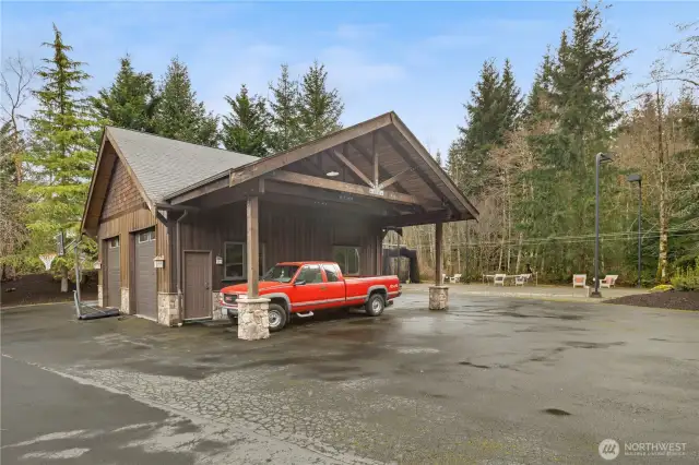 The detached garage is much larger than this photo suggests. 2-4 cars could be parked inside. 2 boats, tractors, snowmobiles, or more. The carport could accommodate an RV or boat. You can see the multisport court just behind it. Plenty or room to park innumerable cars on the tarmac.