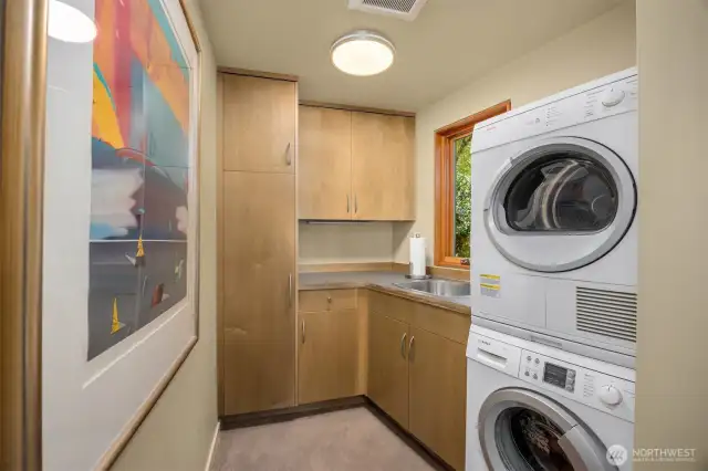 Laundry with utility sink, counter space and storage
