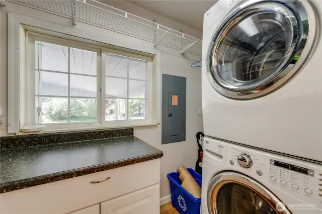 Good sized laundry room with folding table & storage.