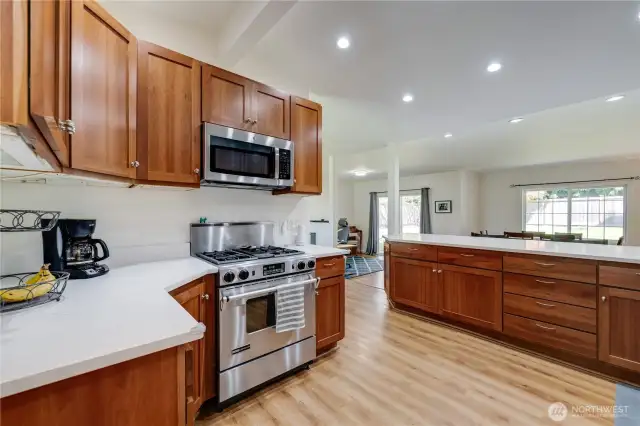 Stainless steel appliances include a gas stove/range.