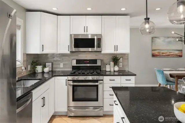 Island kitchen with new subway tile an stainless steel appliances (gas range!)