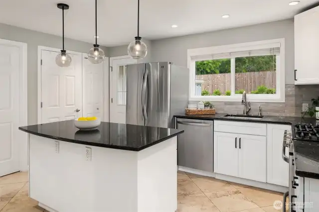 Kitchen kitchen with door to backyard and big garden window overlooking backyard