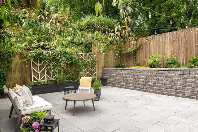 Beautiful 20'x20' patio with string lights and colorful plantings!