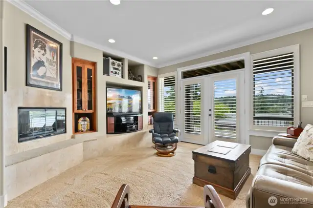 Media room with gas fireplace and its own entry to home