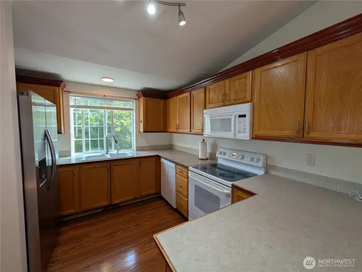 This kitchen provides an abundance of countertop space and cabinetry for convenient accessible storage