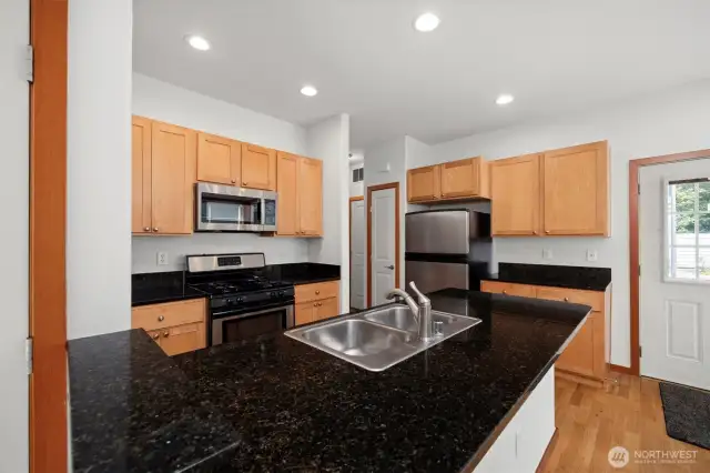There is a 4-burner gas range and a brand new microwave. There is also a pantry and a lot of counter and cabinet space.
