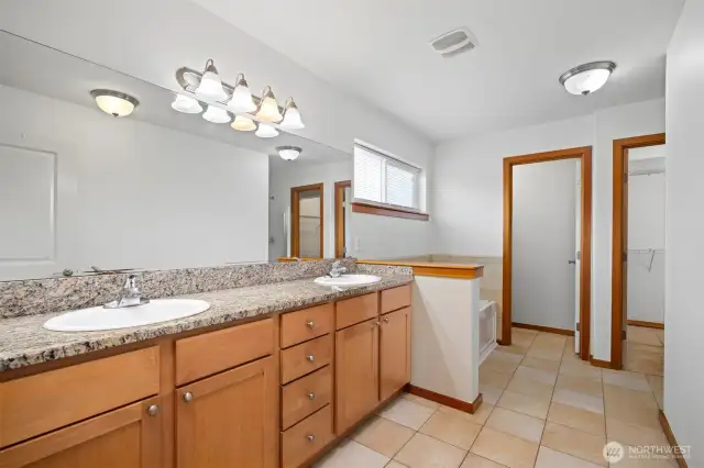 The primary bath is very large and has a dual sink vanity and a toilet room as well as a separate tub and shower.