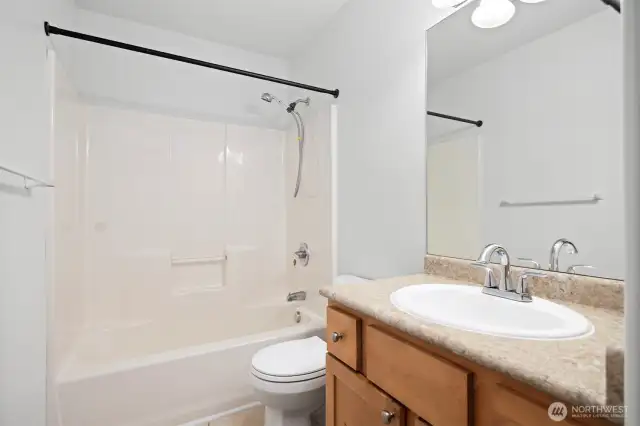 The other full bath is between bedrooms upstairs.