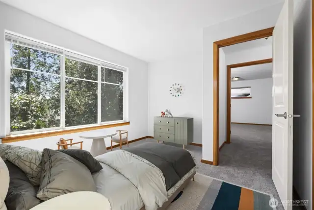 Looking from this bedroom toward the primary bedroom across the hallway.
