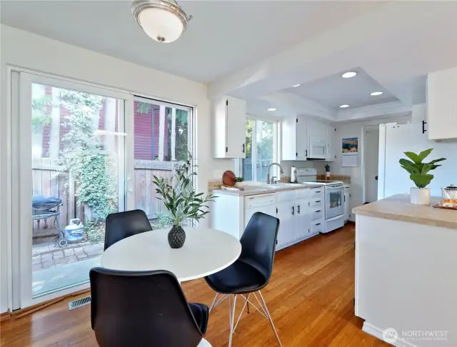 From eating space to kitchen- slider opens to side yard with dog run and gate to front