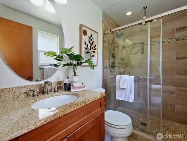 Master bath offers a 5' shower with tile enclosure and two shower heads, the overhead is called a "Rain Dome".   Tile backsplash, floor and tile sink