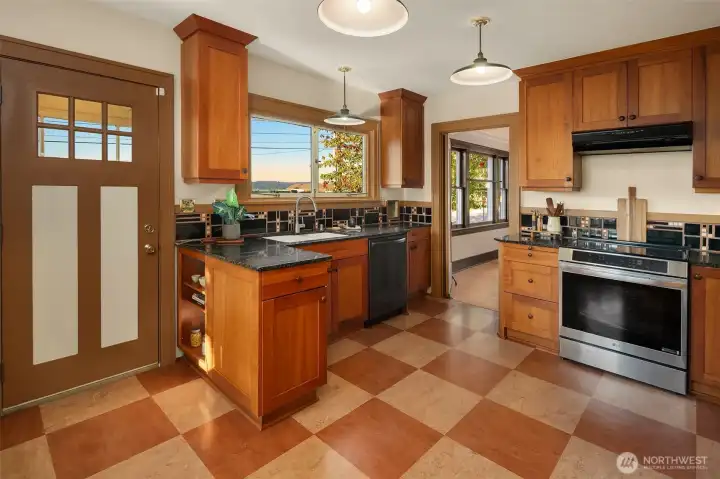 What a cute kitchen with light streaming in and plenty of room to create delicious meals. Not to mention a view out the window!