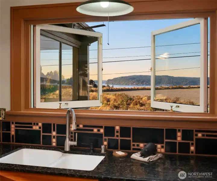 The kitchen window frames a living painting of the Puget Sound.