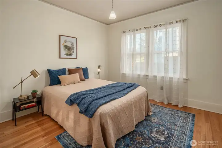 One of two main floor bedrooms with original woodwork and real hardwood floors.