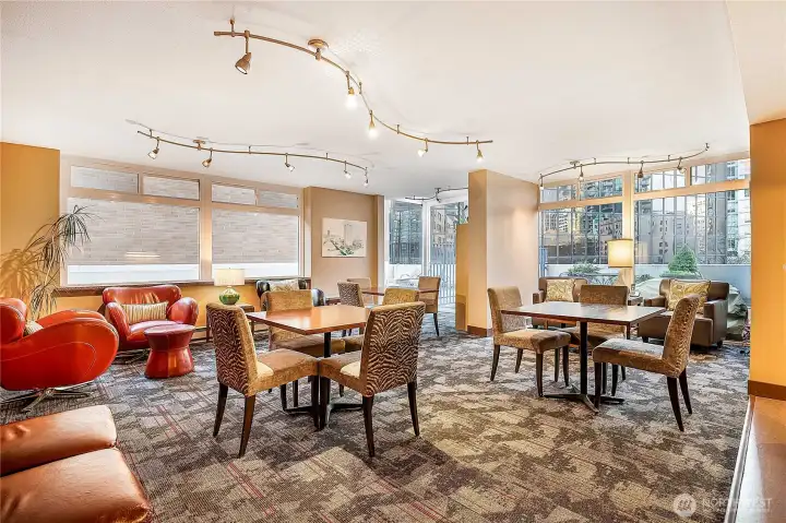 Community room on 4th floor has ample seating, library and kitchen.