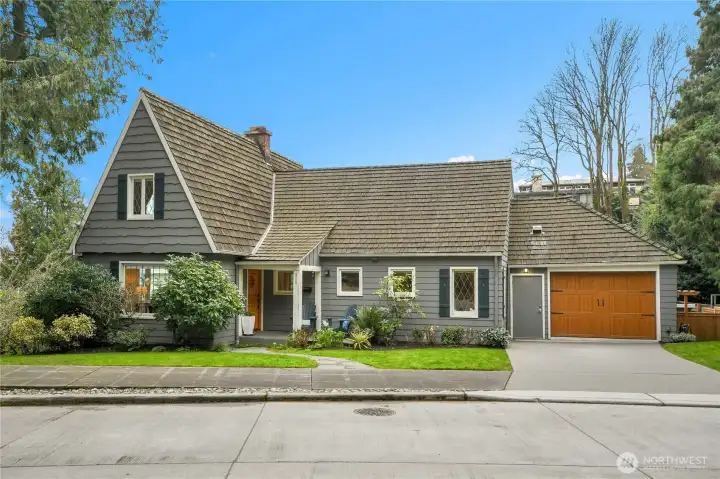 Step into a world where classic elegance meets modern sophistication. This stunning Tudor-style residence, built in 1927, is nestled just one block from the shimmering waters of Lake Washington and moments from the vibrant Leschi shops and dining. From the moment you arrive, the home’s steep shingled rooflines and charming façade evoke the romance of a bygone era, while inside, every detail has been thoughtfully curated for today’s lifestyle.