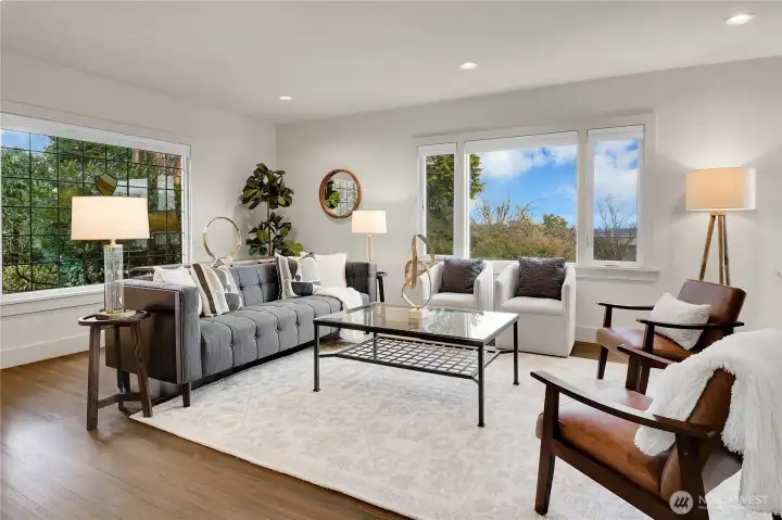 This home retains its original architectural charm with leaded glass windows, coved ceilings, arched doorways, and rich hardwood floors throughout. The cedar shake roof and wood-burning fireplace—now converted to gas—add warmth and authenticity to the space. These timeless features are complemented by extensive updates that make the home as functional as it is beautiful.