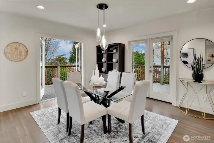 . French doors from the dining area lead to a spacious deck, perfect for entertaining or enjoying serene views of the surrounding landscape. Whether hosting a dinner party or savoring a quiet morning coffee, this space is designed for both elegance and ease.