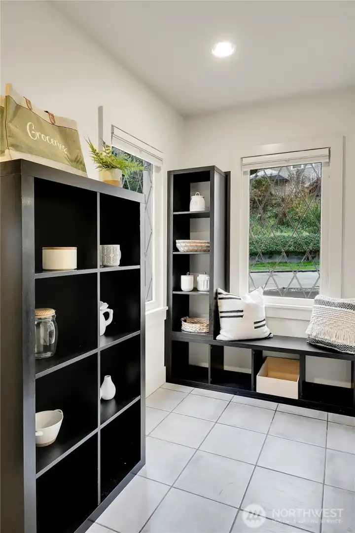 Located between the Kitchen and attached garage is a spacious utility/mud room with laundry, pantry and entrance to the ADU