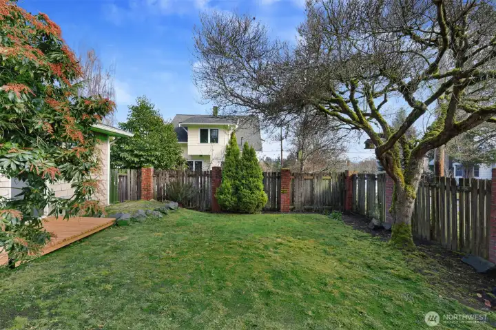 Step outside to your private backyard oasis, framed by mature trees & lush landscaping