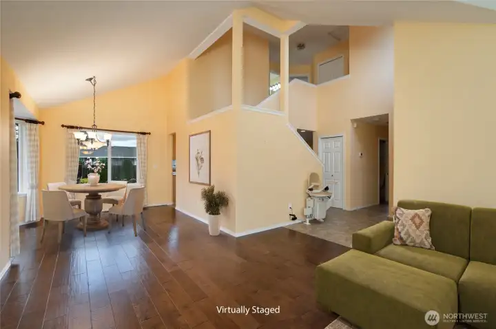 Virtually staged living room toward the dining room.