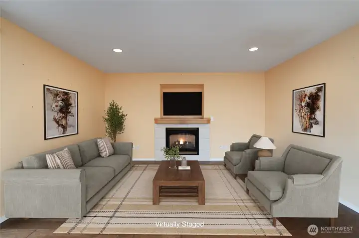 Virtually staged family room with gas fireplace and engineered hardwood floors