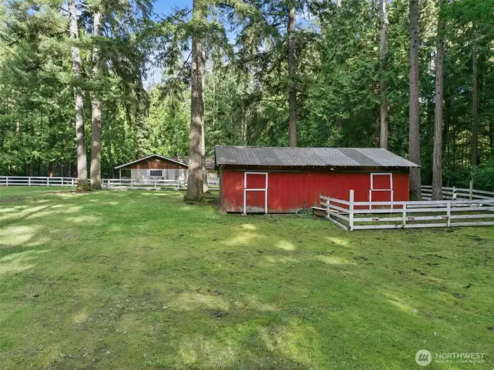 Back pasture is fenced, currently has a fire pit in the center.