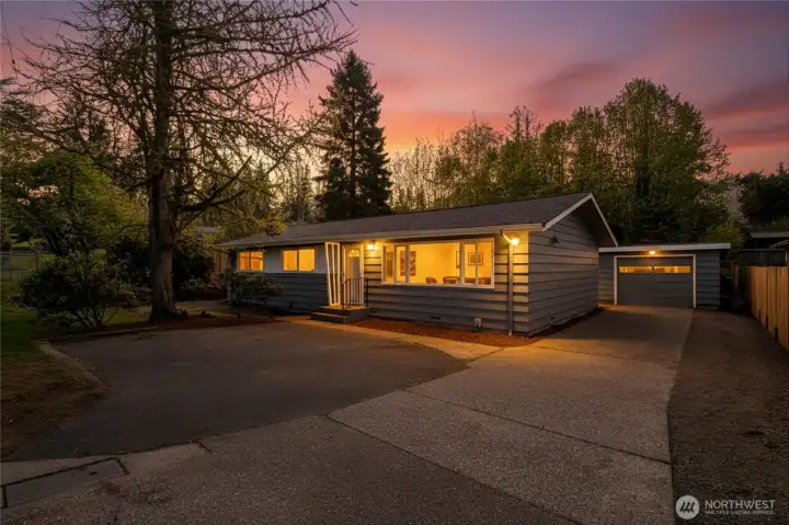 Beautifully remodeled rambler with spacious backyard and mature landscaping in front.