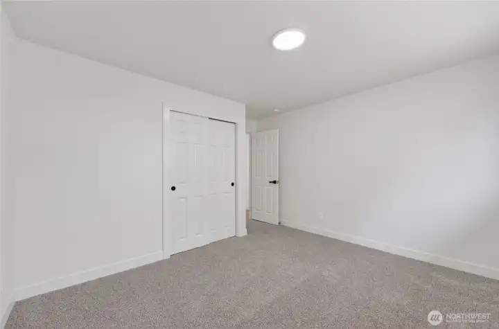 This bedroom features cozy carpet underfoot for comfort.