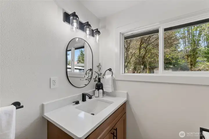Matching vanities in both bathrooms create a cohesive and unified design.