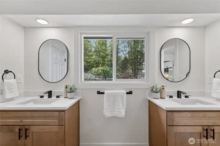 Ensuite bath off the primary bedroom features a double-vanity.