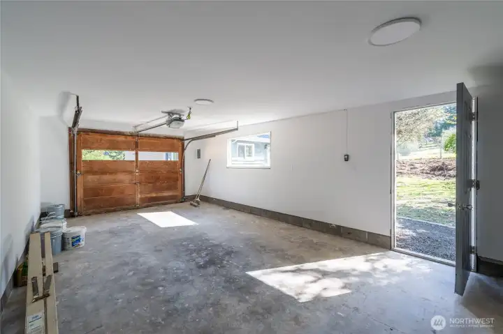 Detached garage with added insulation and finished walls offers flexibility for storage, hobbies, or a workshop.