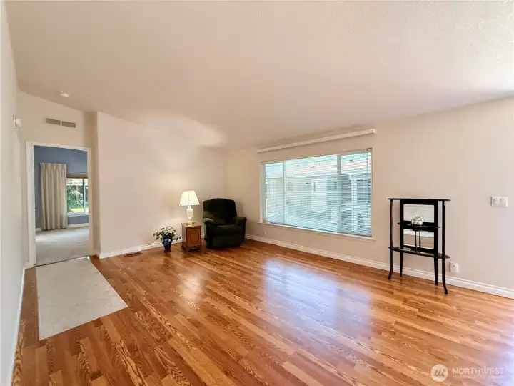 Another view of the living room, with the primary suite beyond.
