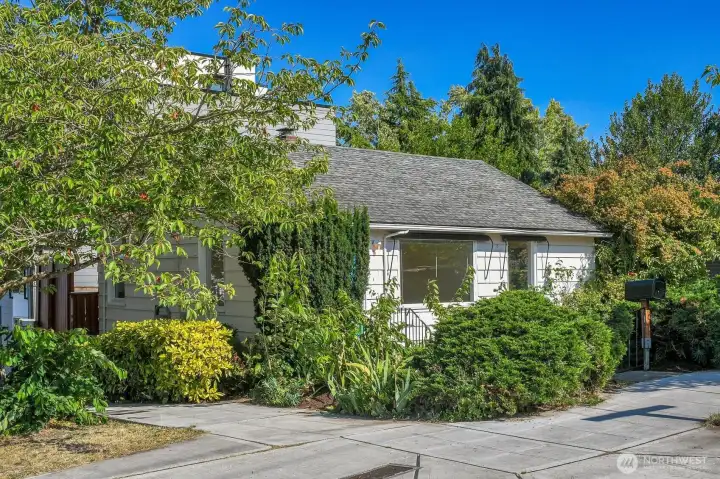 Cherry trees and rose bushes frame this sweet home on a corner lot. Cherry trees and rose bushes frame this sweet home on a corner lot.
