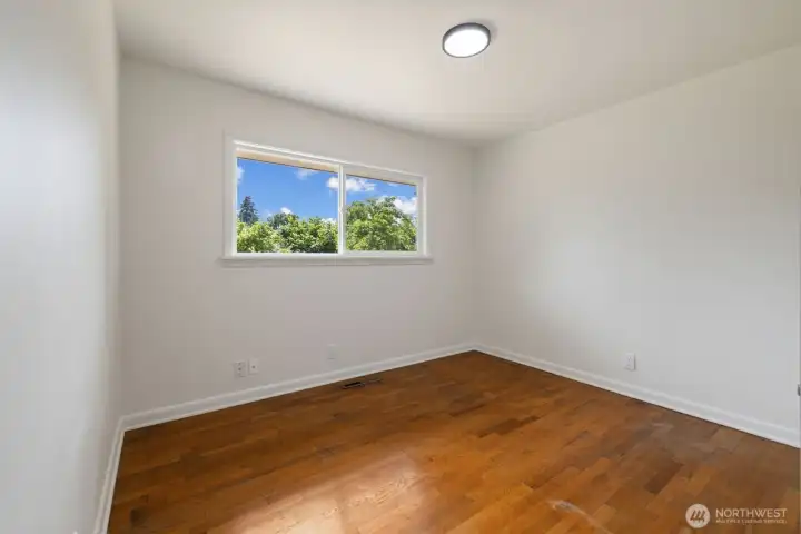 Window view of 1st secondary bedroom acroos from bathroom.