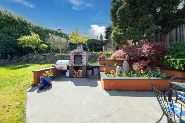 Private, sunny patio and terraced back yard has it all: entertaining space, lawn, world-class tomato growing conditions, established plantings, outbuilding.